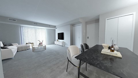 A modern living room with a black table and white furniture.