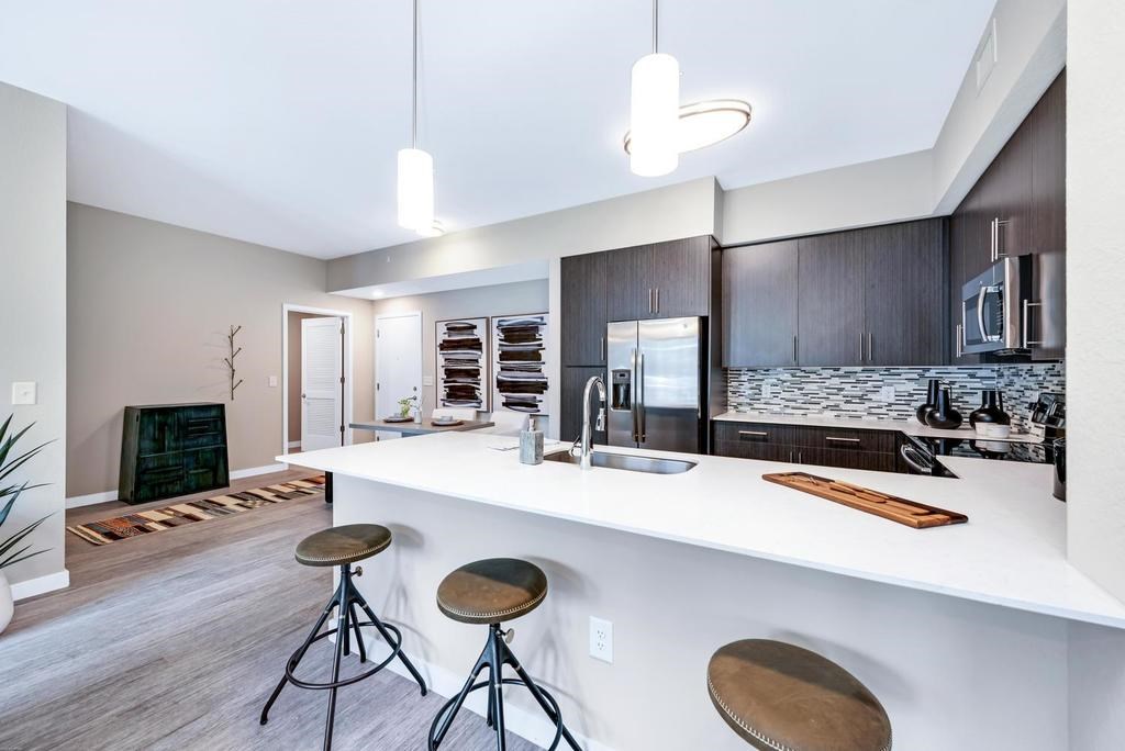 Large kitchens with quartz countertops and stainless steel appliances