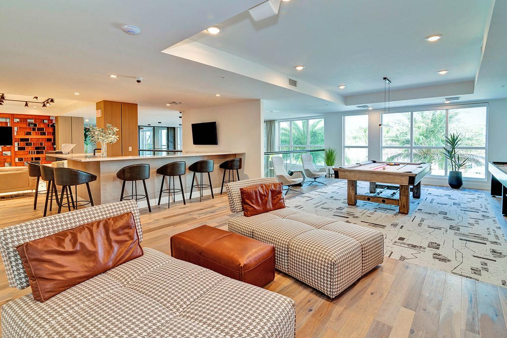 Clubhouse lounge with shuffleboard, pool table and bar area