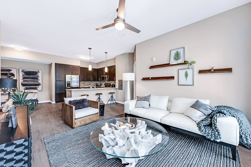 Open concept living room with ceiling fan