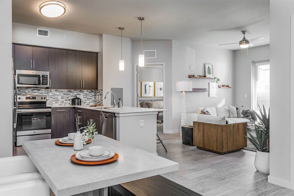 omfortable dining area overlooking spacious living room with natural light