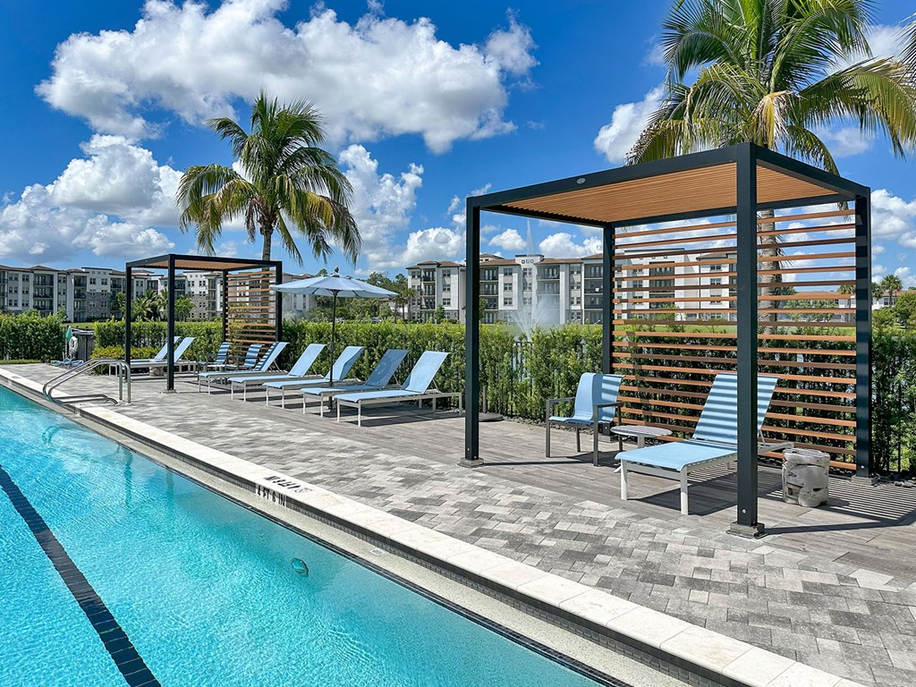 Saltwater pool overlooking private lake with fountains