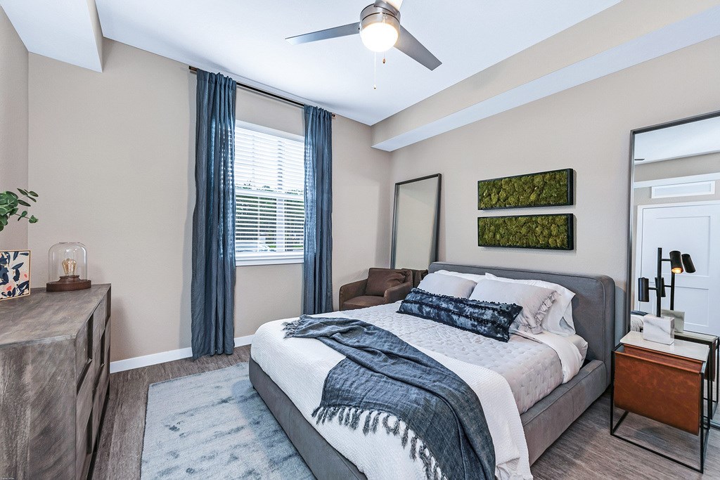 Bedrooms with hardwood-inspired flooring and ceiling fan