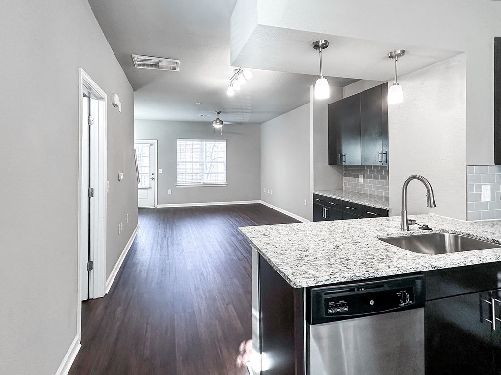 Open concept townhome with kitchen overlooking living and dining areas