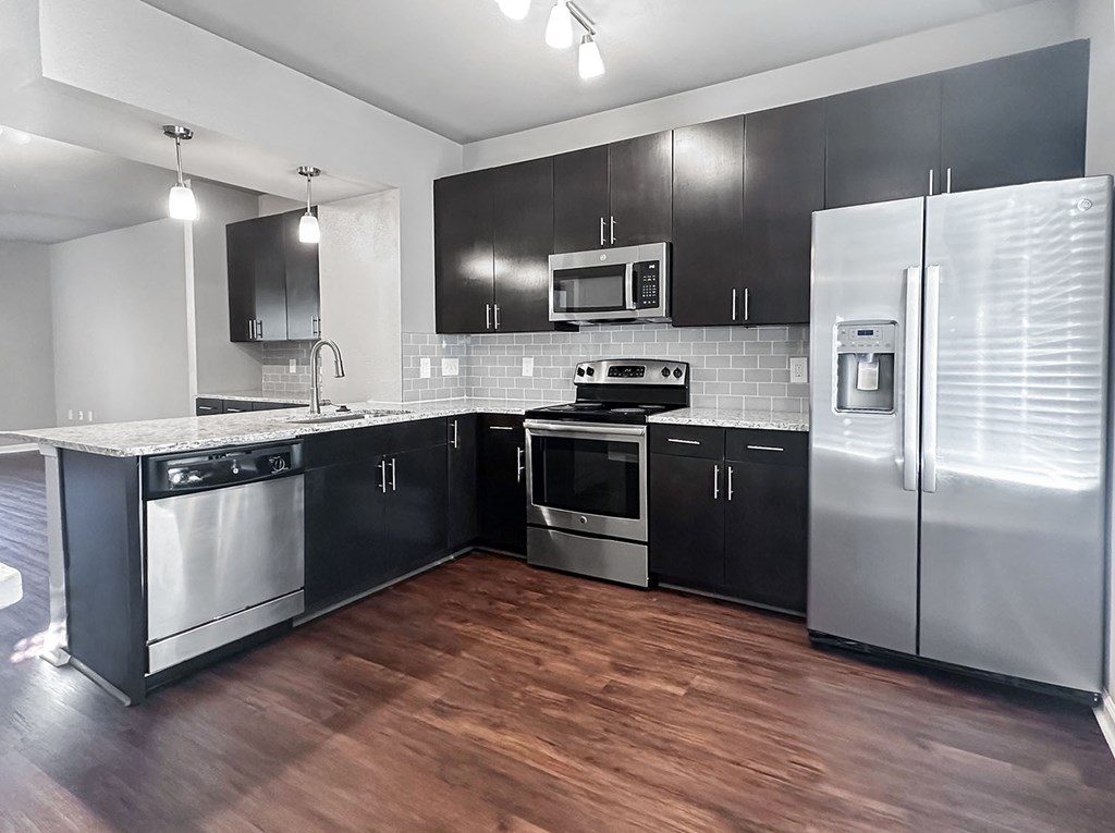 Townhome kitchen with granite countertops and stainless steel appliances