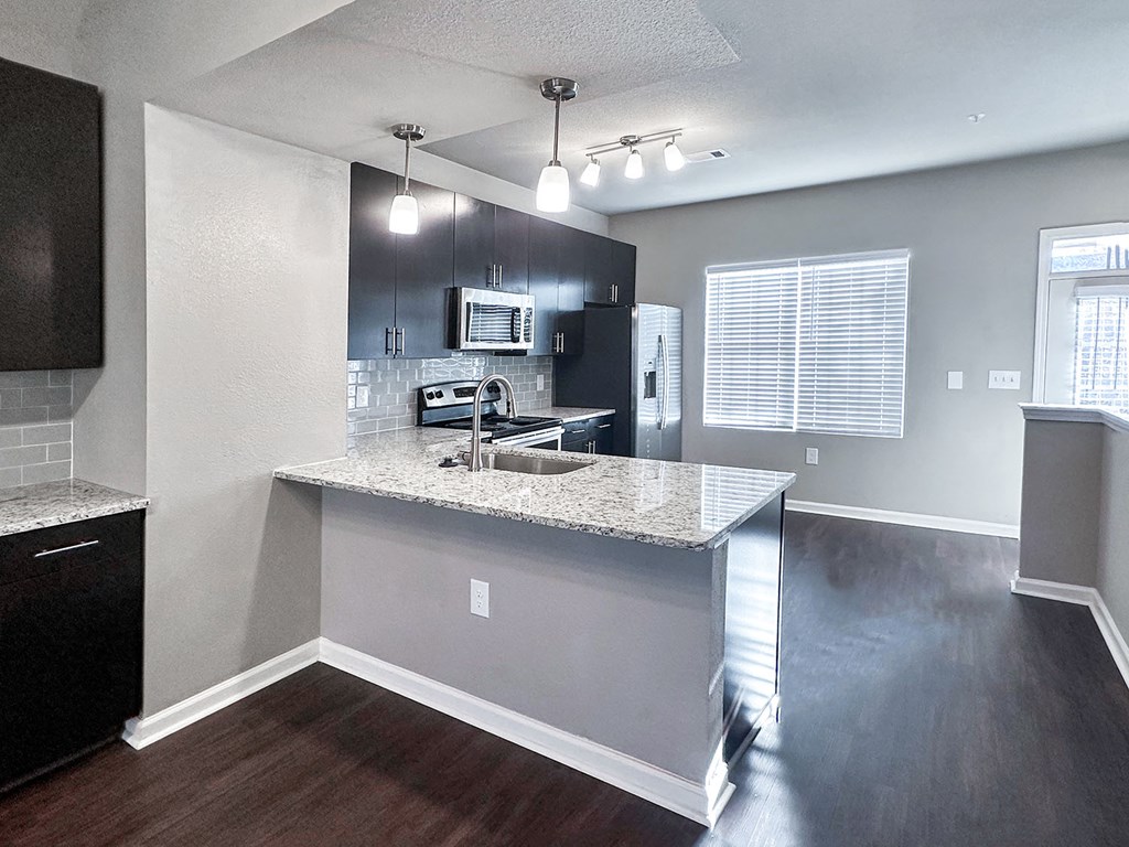 Townhome kitchen with granite countertops and stainless steel appliances