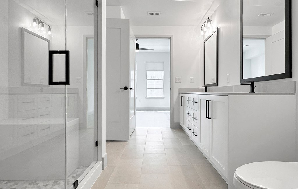 Frameless walk-in showers with stone flooring