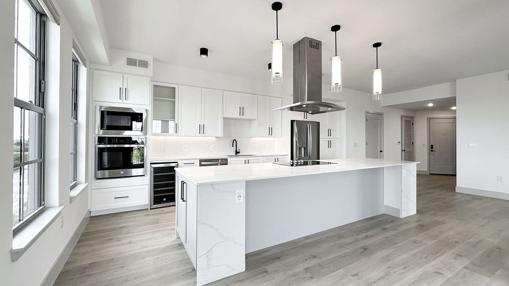 Expansive kitchens and islands with stainless steel appliances