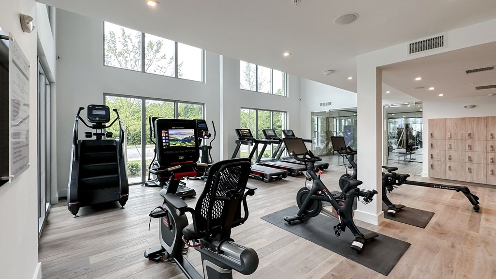 Bi-level fitness studio with cardio machines and stationary bikes
