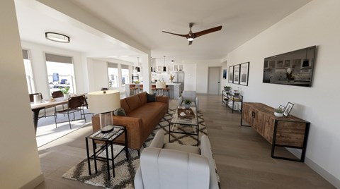 A living room with a brown couch and a rug.