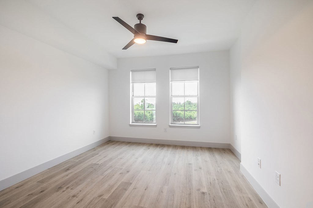 Large main bedrooms with overhead lighting and ceiling fans