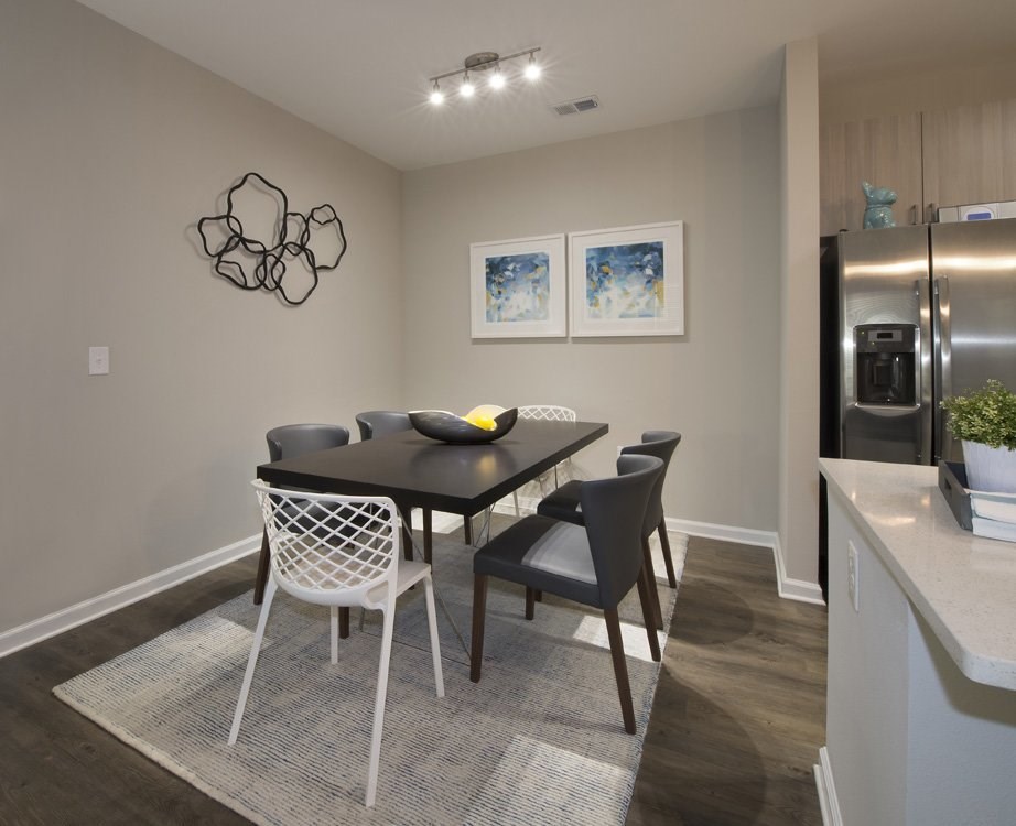 Dining room with overhead lighting and hardwood-inspired flooring