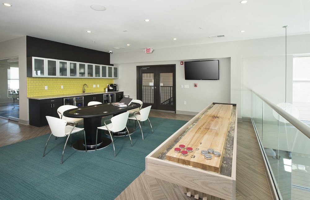 Game room with shuffleboard and poker table