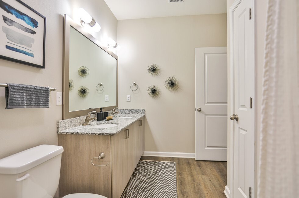 Dual vanities with granite countertops and framed mirrors