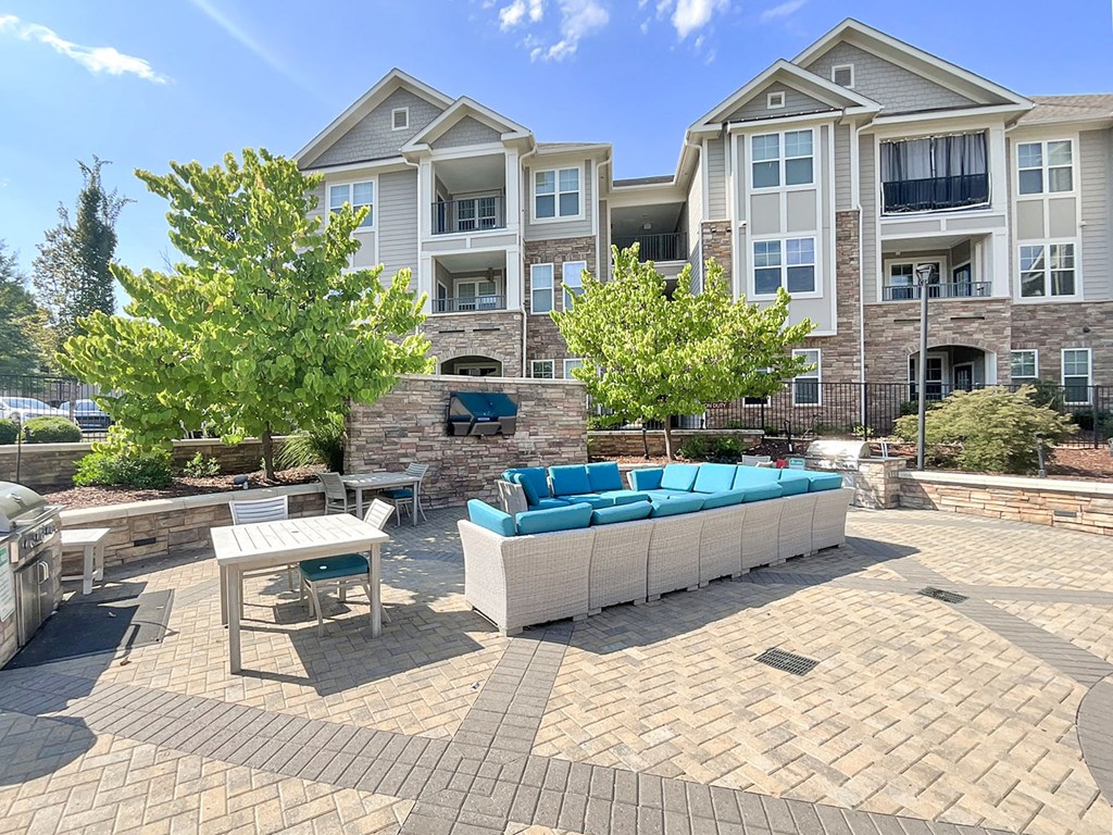 Outdoor living space for entertaining with gas grills, fire pit, entertainment lounge and game area
