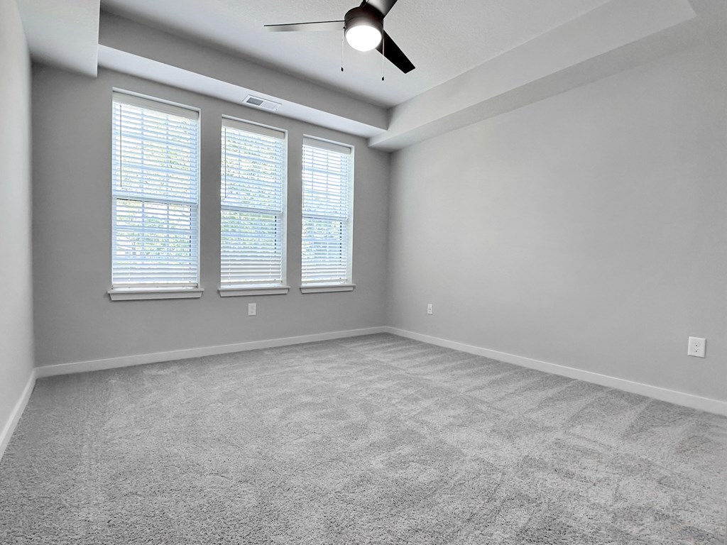 Bedrooms with overhead lighting and ceiling fan