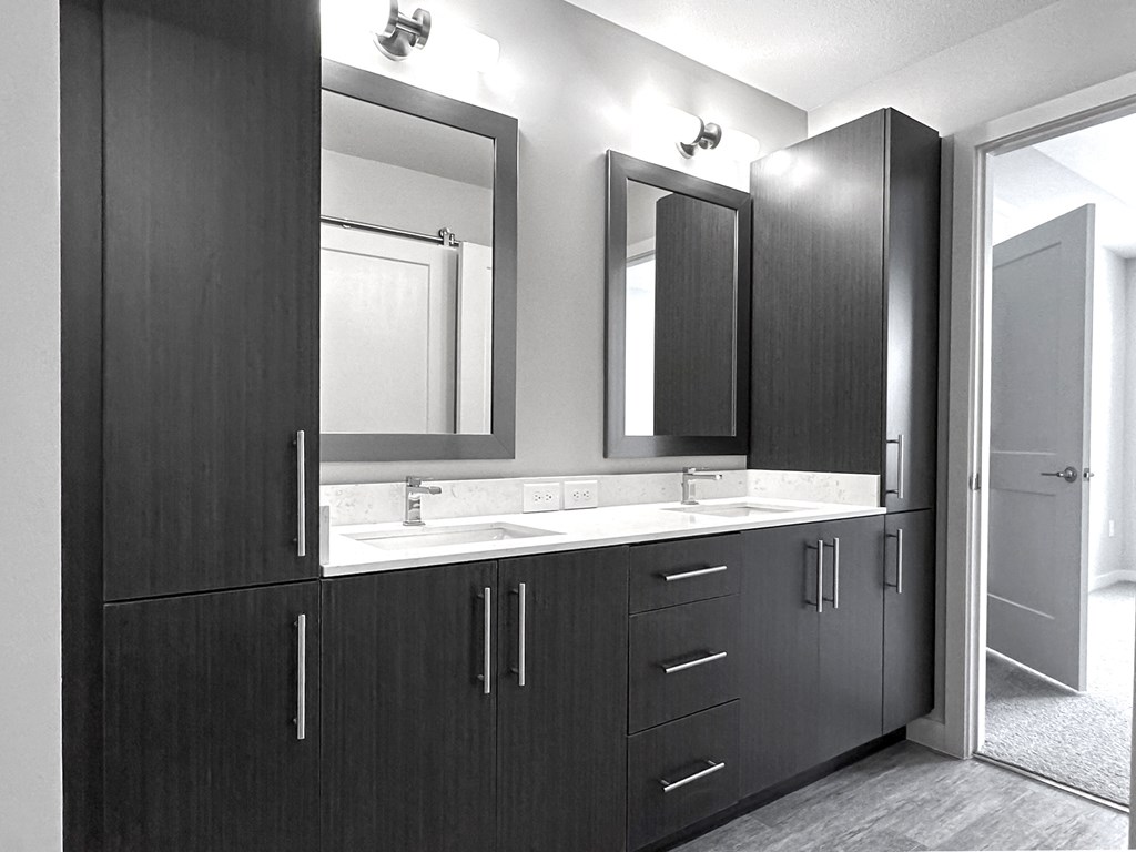 Bathrooms with double vanities, framed mirrors and plenty of storage