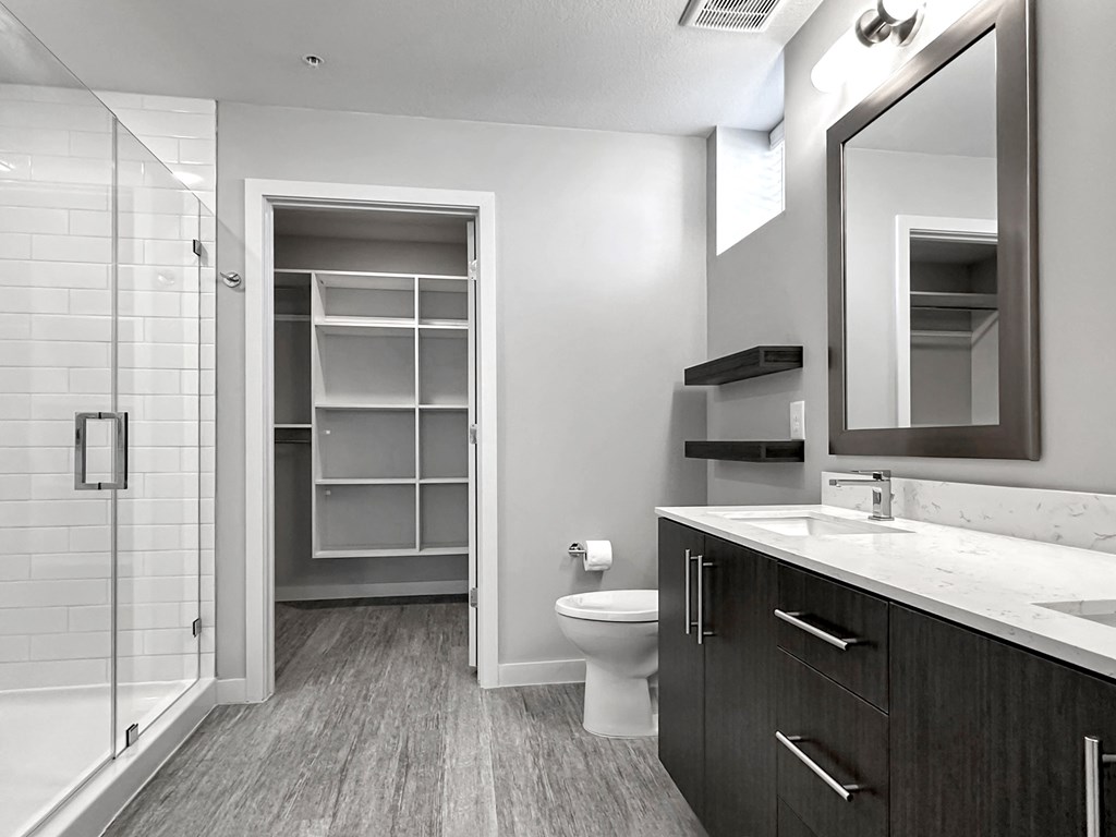 Frameless walk-in showers and large closets with custom shelving