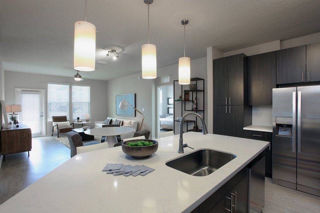 Quartz countertops and islands with overhead lighting