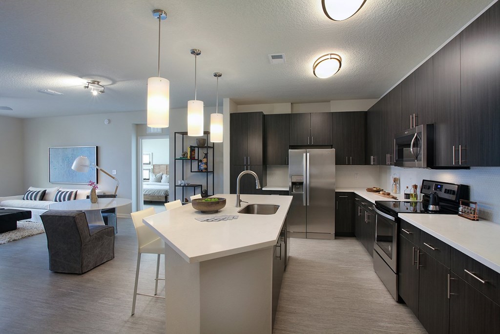 Large kitchens with stainless steel appliances and tile backsplash