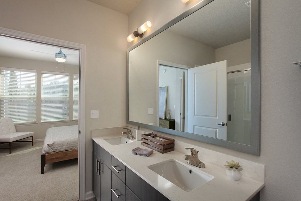 Bathrooms include quartz countertops, dual vanities and framed mirrors