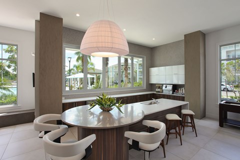 A modern kitchen with a round table and chairs.