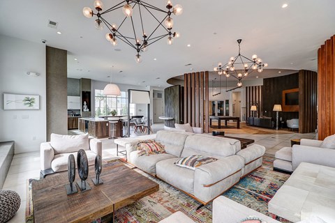 A modern living room with a white sofa set and a wooden coffee table.