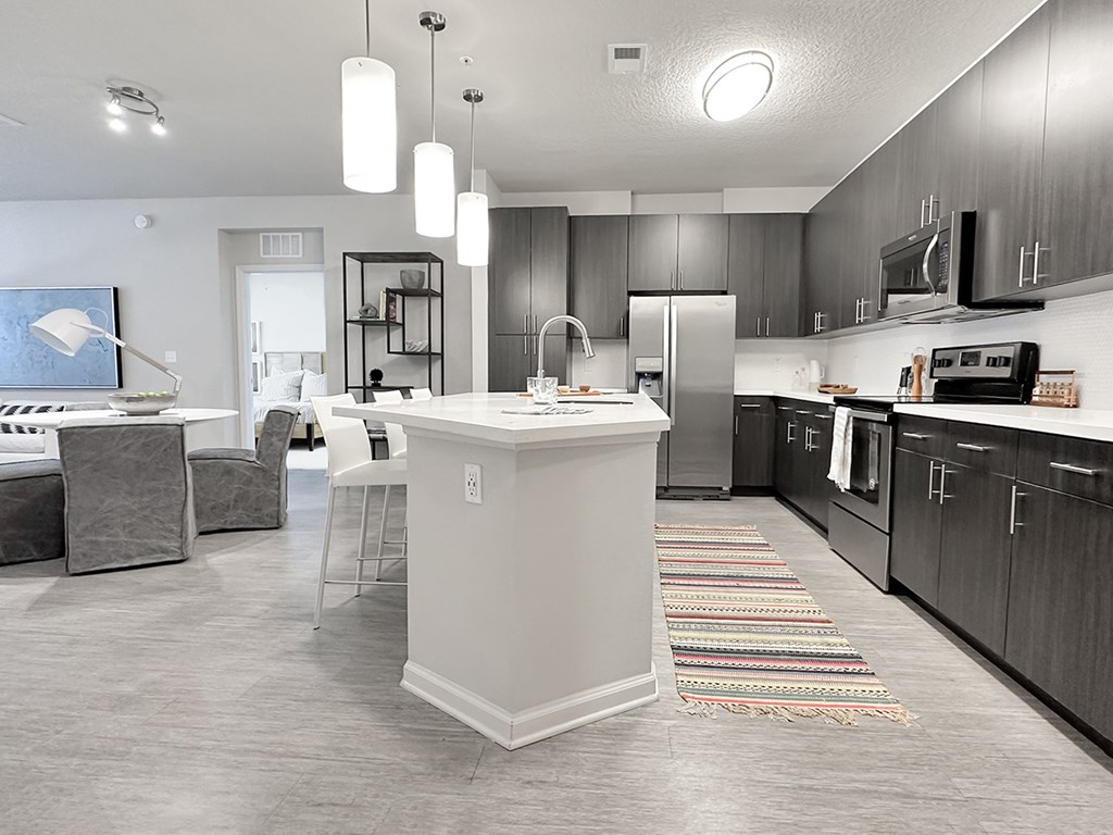 Open concept floor plans with fireplaces and large islands with bar seating