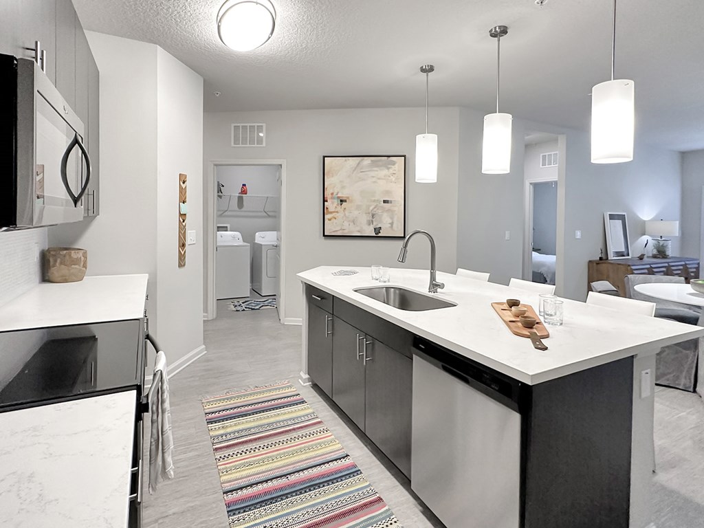 Quartz countertops and islands with overhead lighting