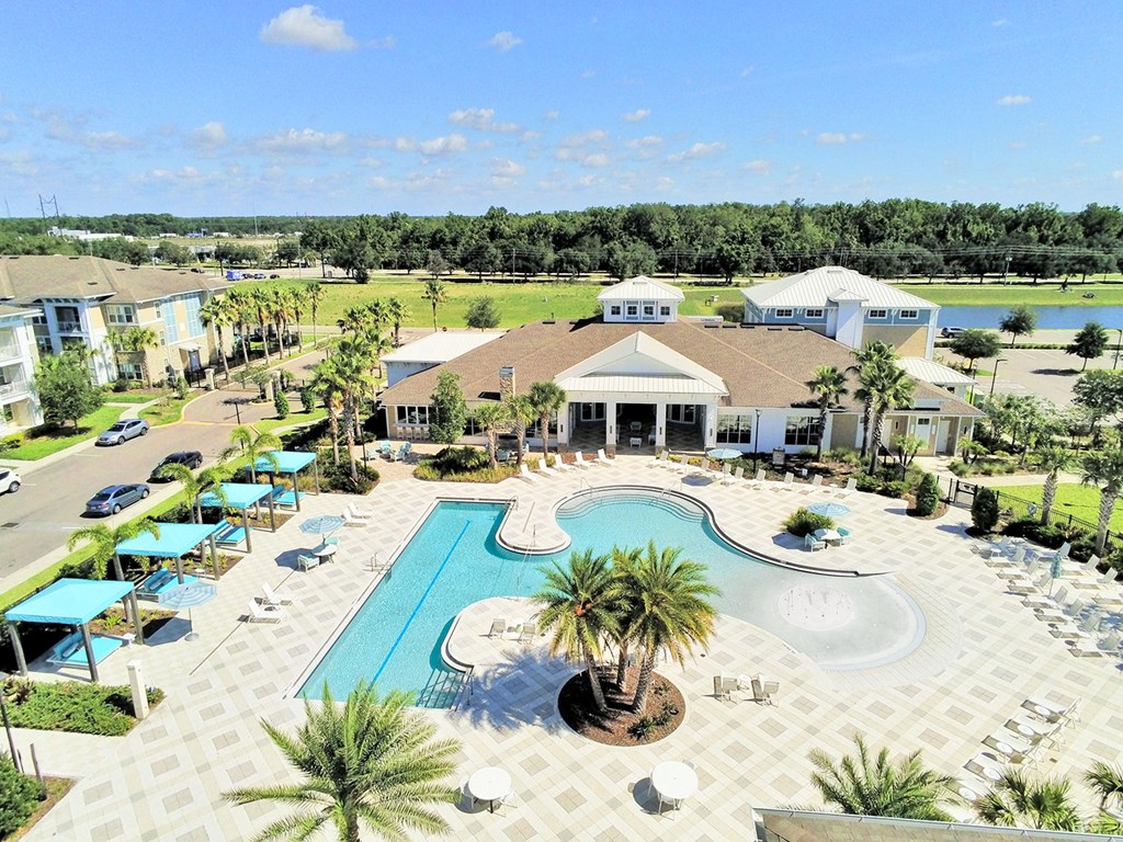 Beach-entry saltwater pool with splash pad, volleyball net, swim lane and cabanas