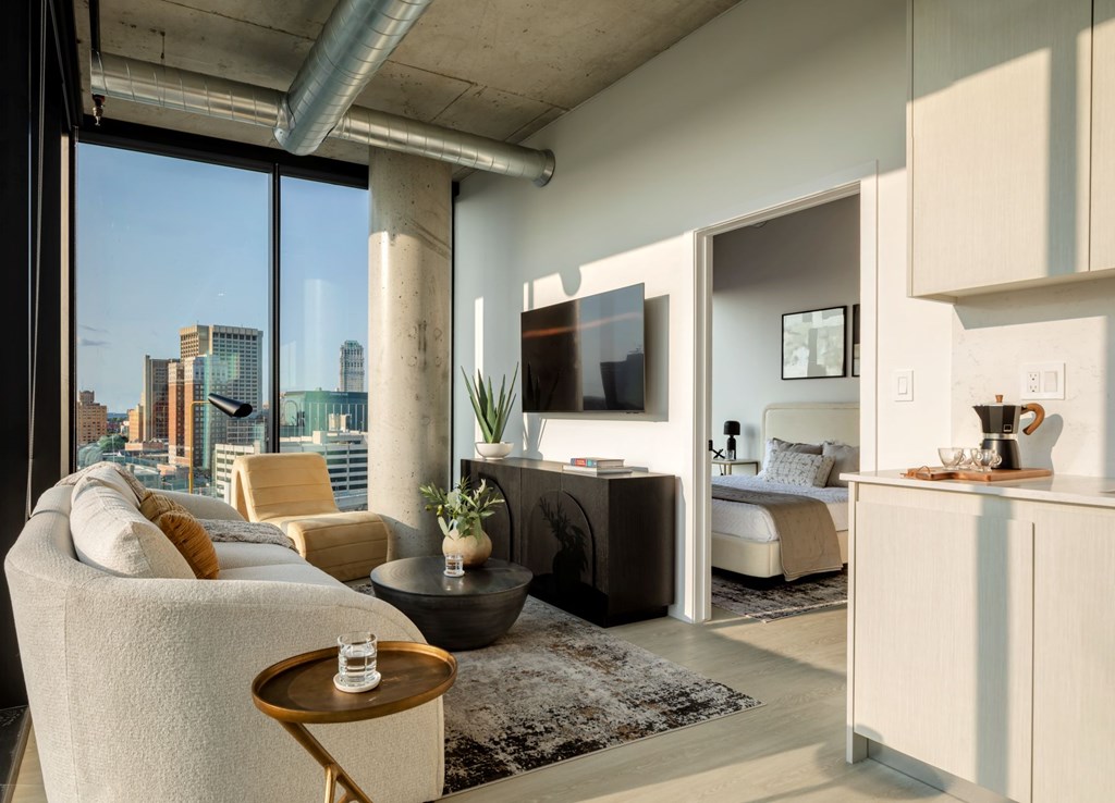 A modern living room with a large window overlooking the city.