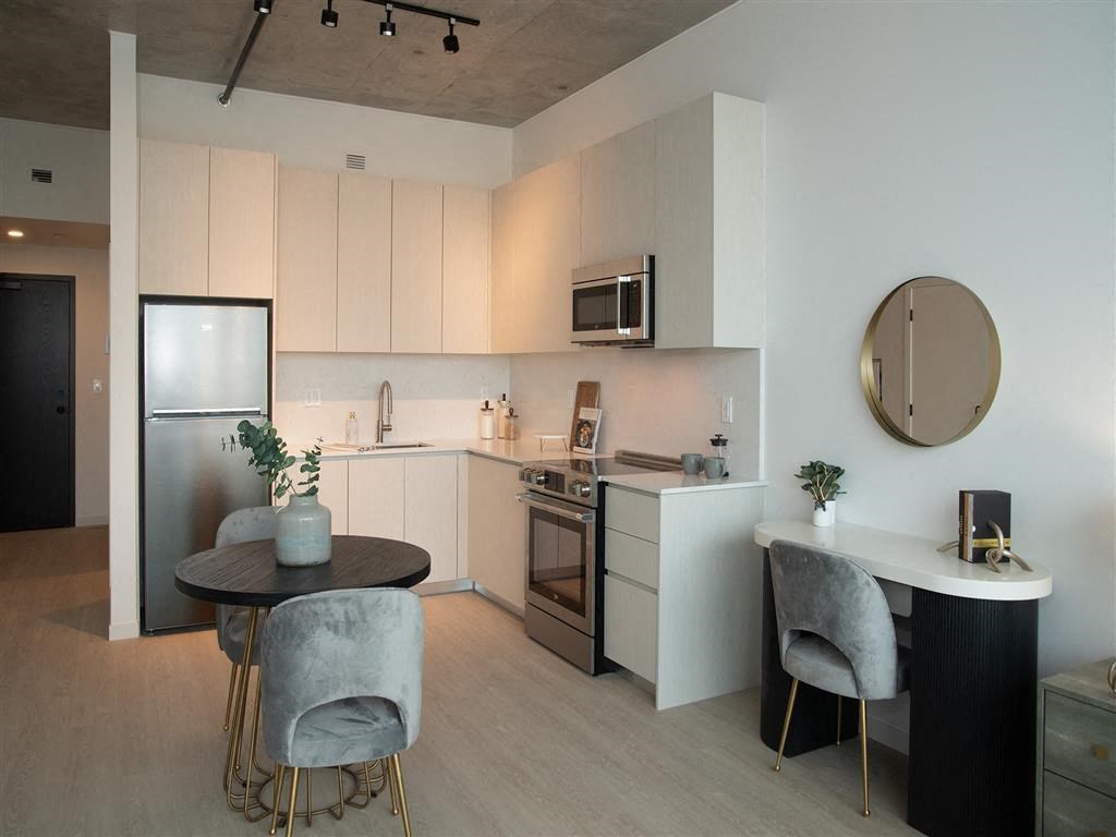 A modern kitchen with a table and chairs.