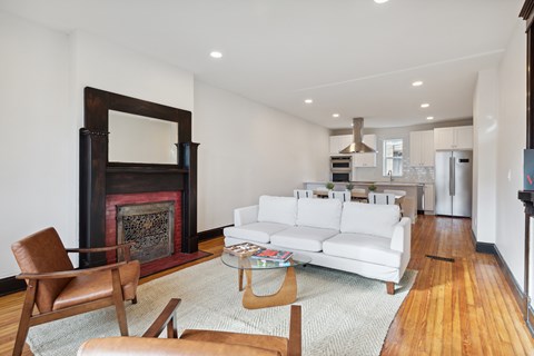 A living room with a fireplace and a white couch.