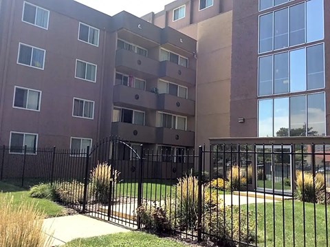 A tall building with a black fence in front of it.