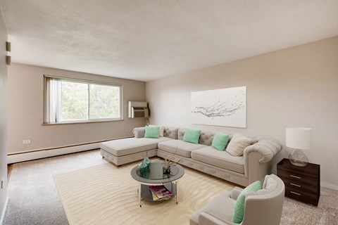 A living room with a white couch and a coffee table.
