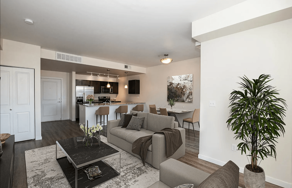 A living room with a couch, chairs, and a coffee table.