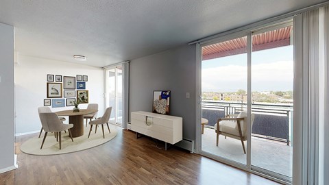 A modern dining room with a table set for four.