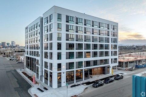 A modern building with a glass facade is shown in the image.