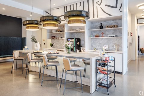 A modern kitchen with a dining table and chairs.
