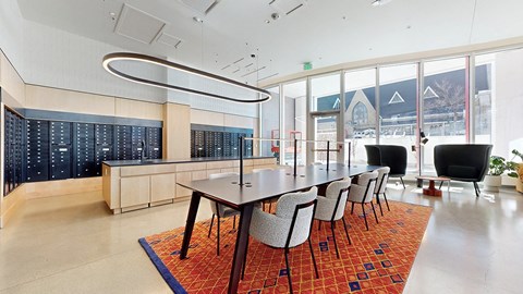 A conference room with a long table and chairs.