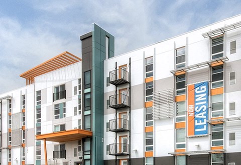 A multistory building showing exterior of Avenue 8 at Mayfair.