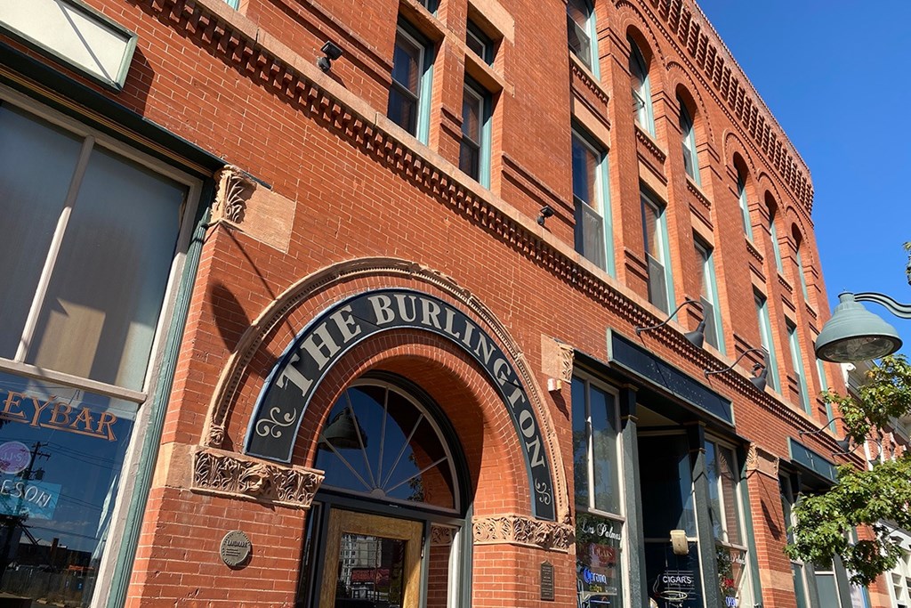 Exterior brick facade of The Burlington apartments showing  main entry door.