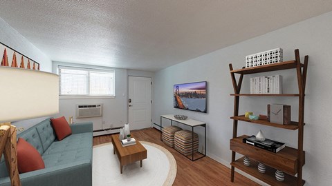 A living room with a blue couch, a wooden coffee table, and a television on the wall.