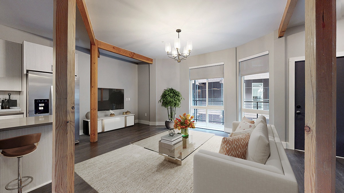 A modern living room with a white couch and a coffee table.