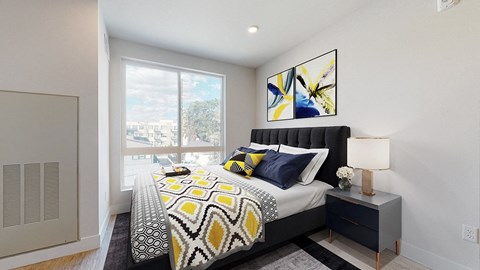 A bedroom with a large bed and a painting on the wall.