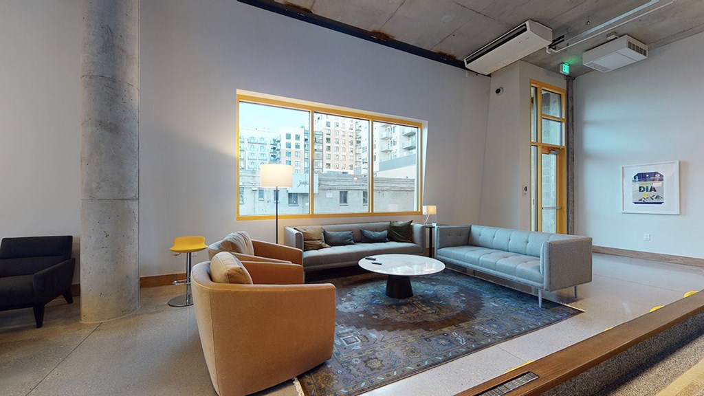 A modern living room with a large window and a view of the city.