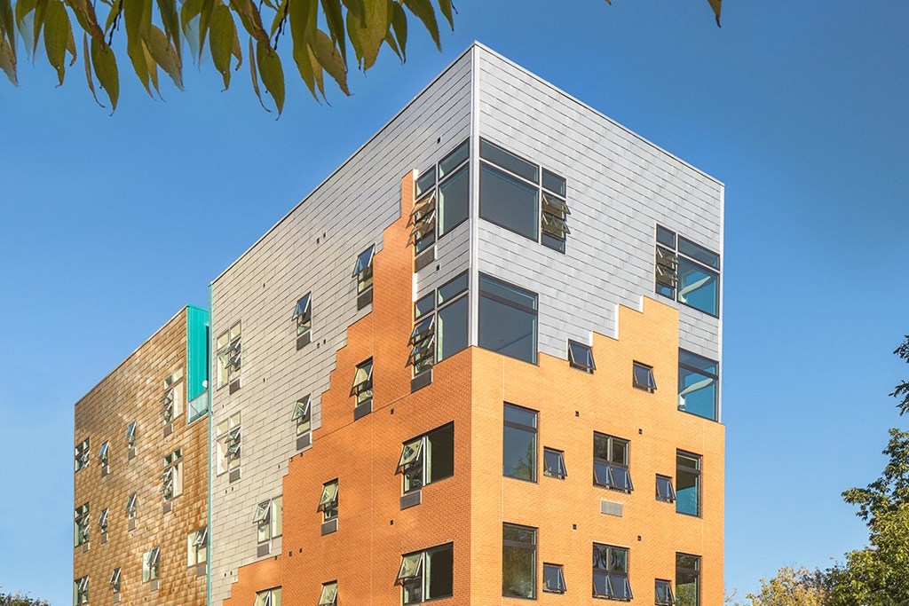 A modern building with a combination of orange and grey bricks.