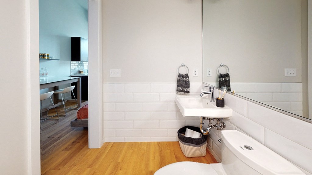 A white bathroom with a white tub and toilet.