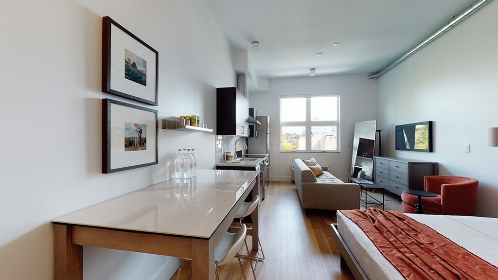 A modern kitchen with a dining table and chairs.