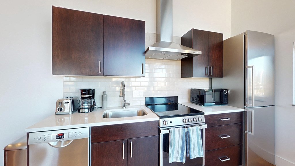 A kitchen with a stove top oven and a dishwasher.